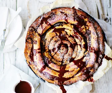 Giant skillet chocolate and cinnamon spiral with chocolate sauce