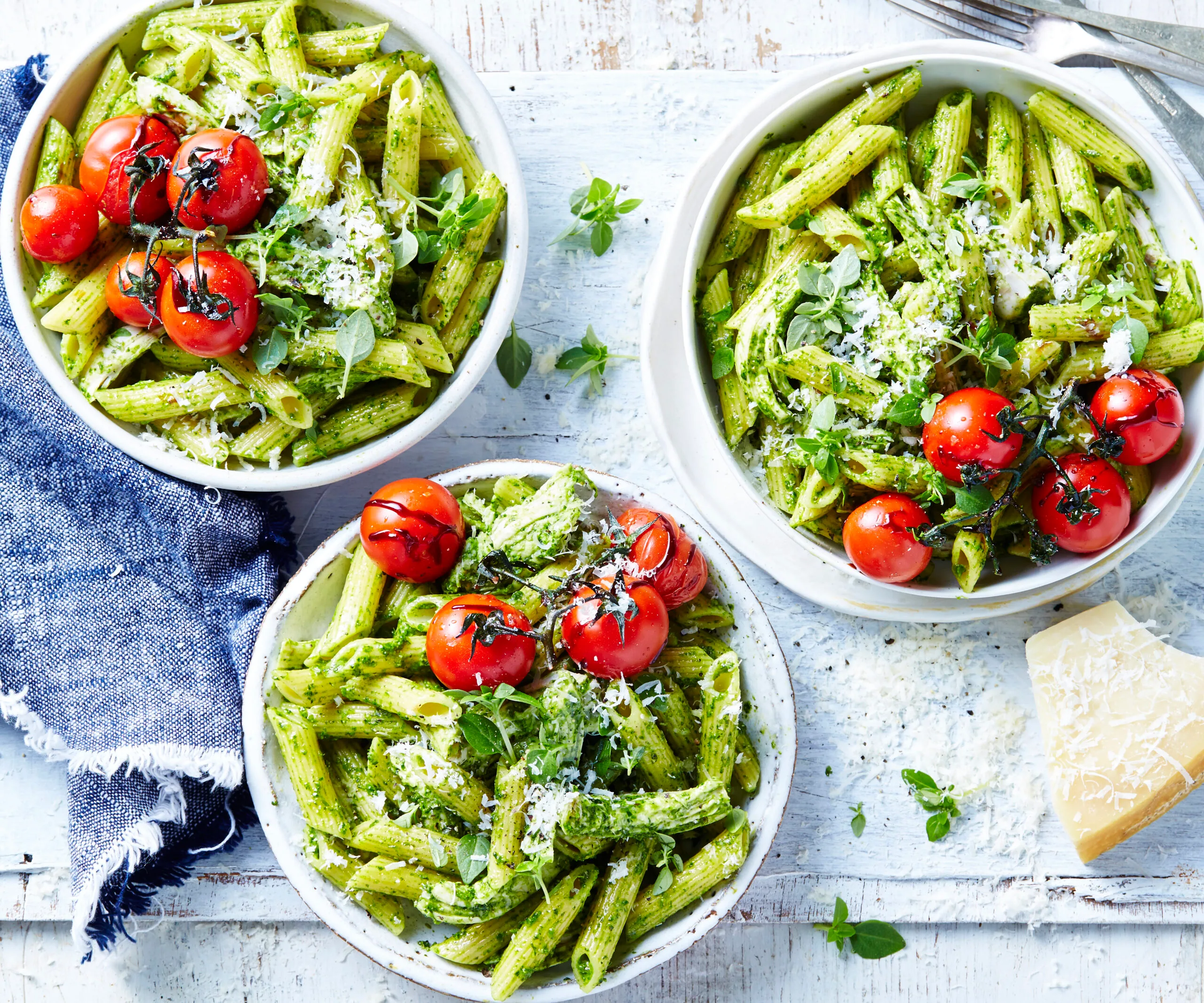 chicken pesto pasta with cherry tomatoes in bowls