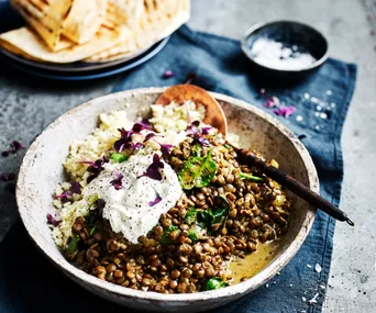 meatless slow cooker lentil stew in a bowl with a spoon