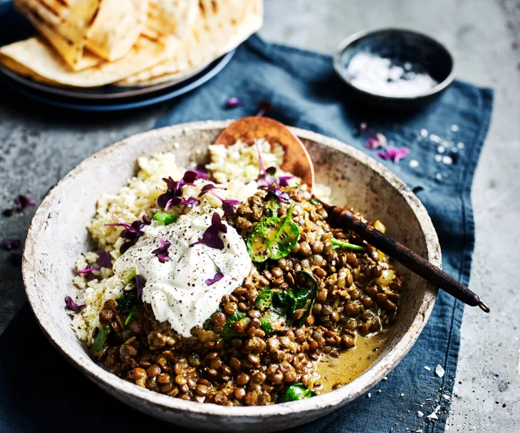 meatless slow cooker lentil stew in a bowl with a spoon