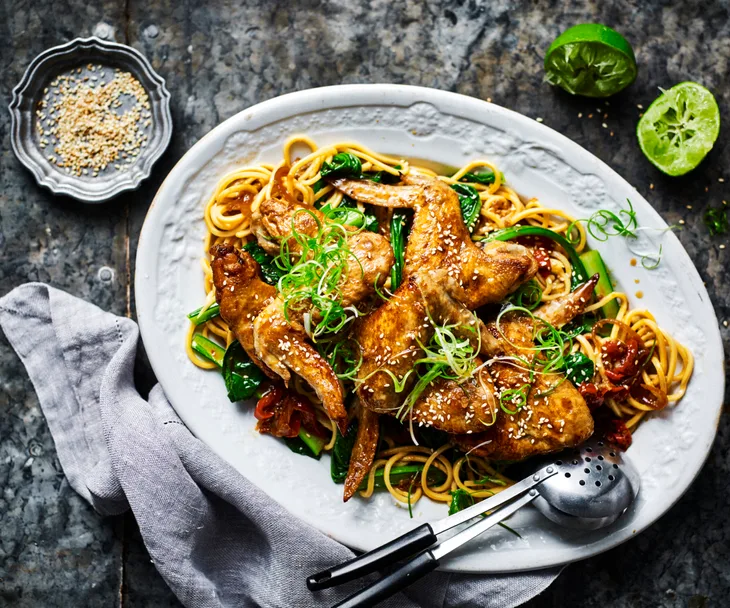 Soy-glazed chicken wings with noodles