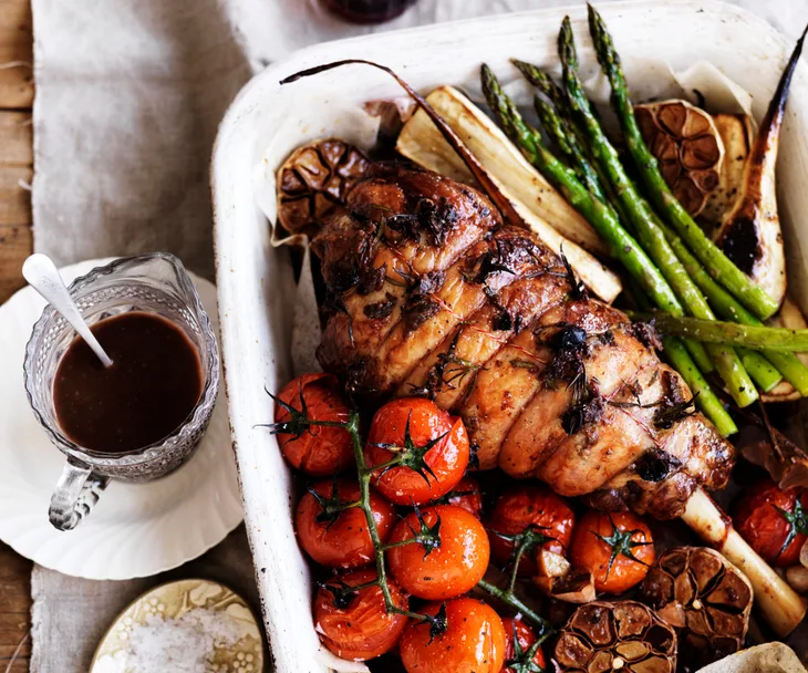 Roast lamb with anchovies, garlic and vegetables