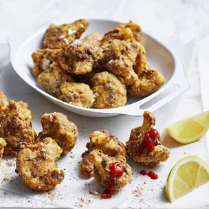 air fryer cauliflower bites with lime wedges
