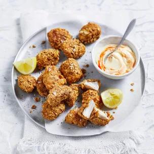 air fryer Gluten free chicken nuggets on a plate with lemon wedges