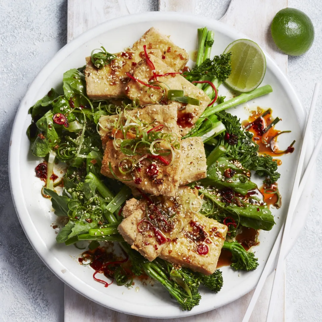 crispy air fryer tofu on green vegetables