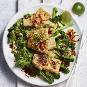 crispy air fryer tofu on green vegetables