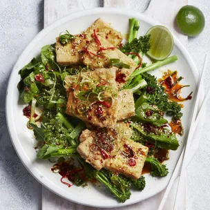 crispy air fryer tofu on green vegetables