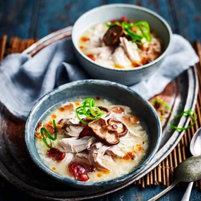 two bowls of Slow cooker chicken congee with mushroom and green onion