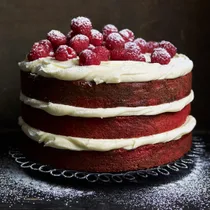 gluten free red velvet layer cake with cream cheese frosting and raspberries