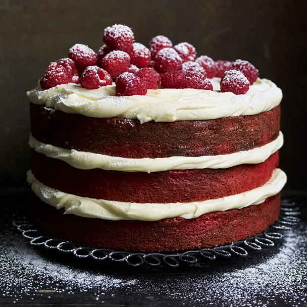 gluten free red velvet layer cake with cream cheese frosting and raspberries