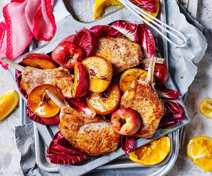 Pork cutlets with sweet and sticky apple and radicchio on a platter