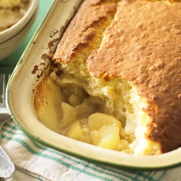 Baked apple sponge pudding in a dish
