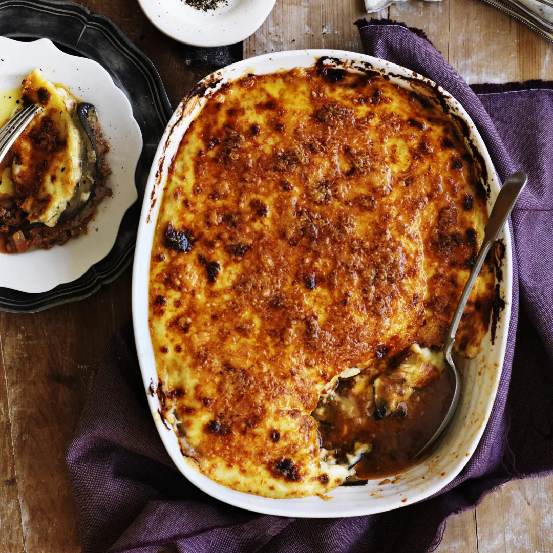 moussaka in a serving dish with a spoon