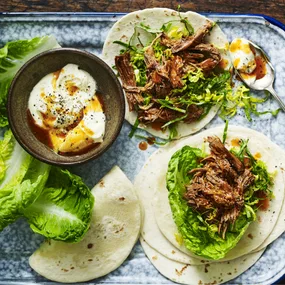 slow cooker beef tacos with lettuce and sour cream