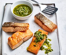 air fryer salmon with crispy skin and topped with salsa verde