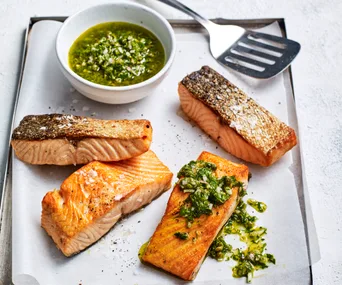 air fryer salmon with crispy skin and topped with salsa verde