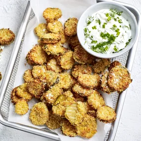 a basket of air fryer pickle chips with dipping sauce