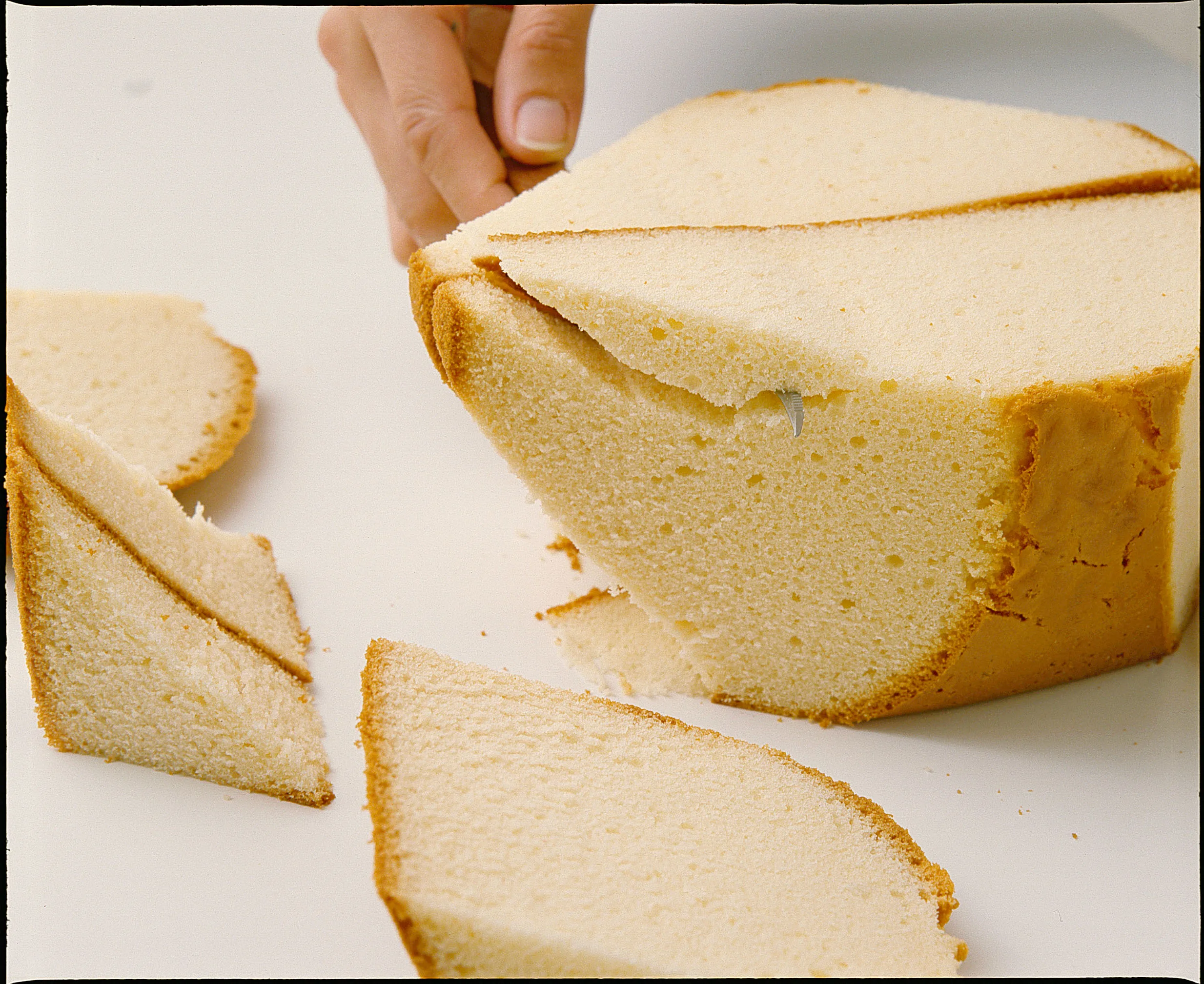 The Duck Cake's body is made by cutting the tail end at an angle and shaping it.