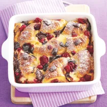 croissant bread and butter pudding with chocolate and raspberries in a square dish