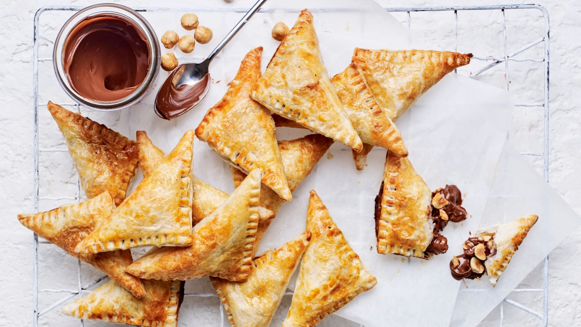 nutella puff pastry turnovers with a jar of nutella
