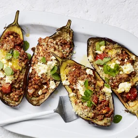 four halves of air fryer eggplant stuffed with lentils and tomato
