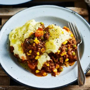 easy slow cooker cottage pie in a bowl with a fork