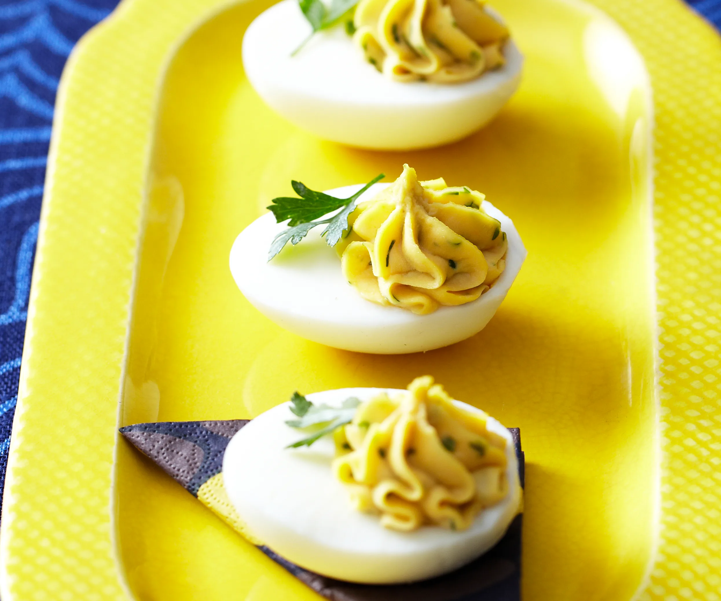 Devilled eggs on a yellow platter