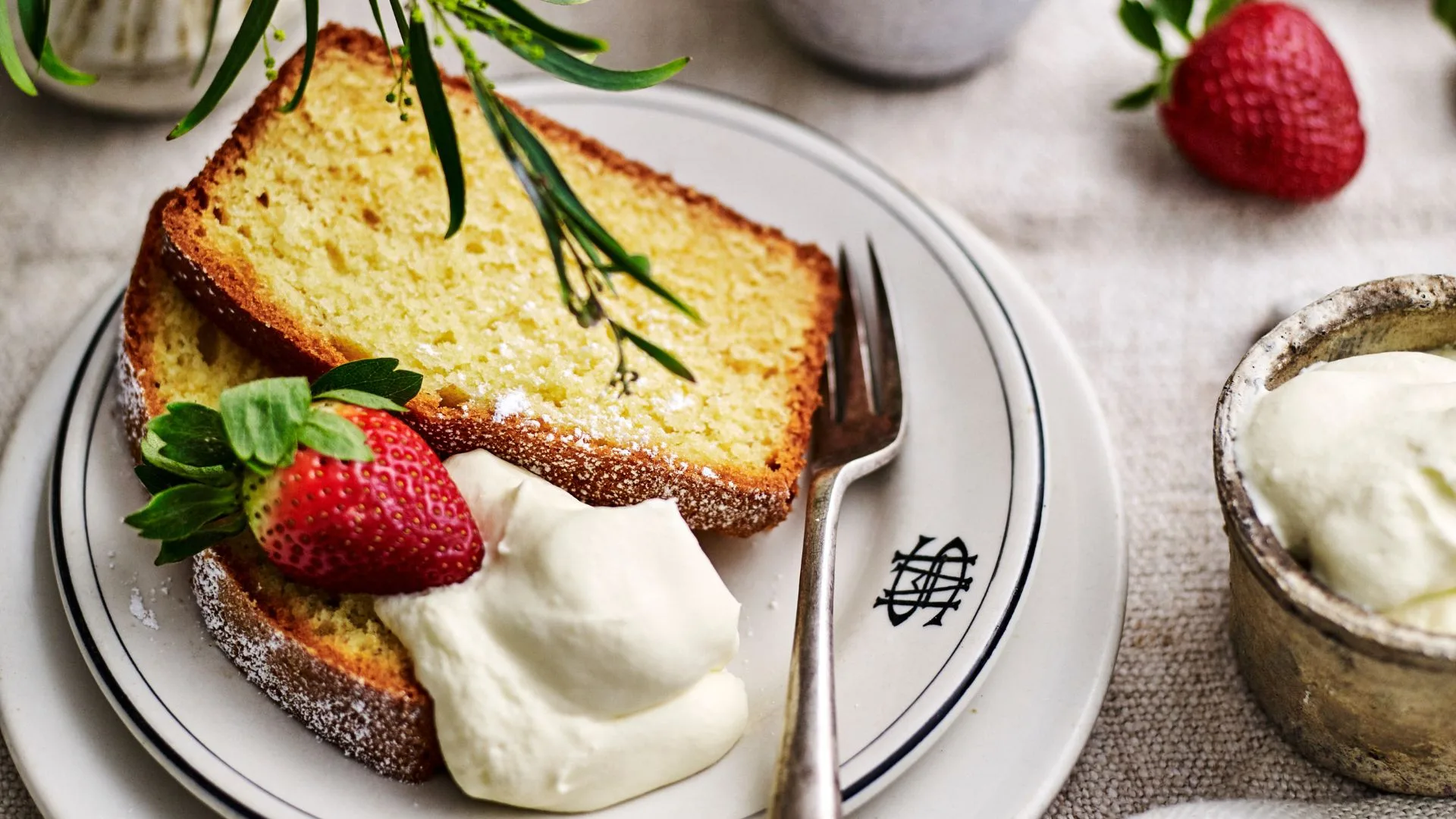 Slice of pound cake with whipped cream and strawberries