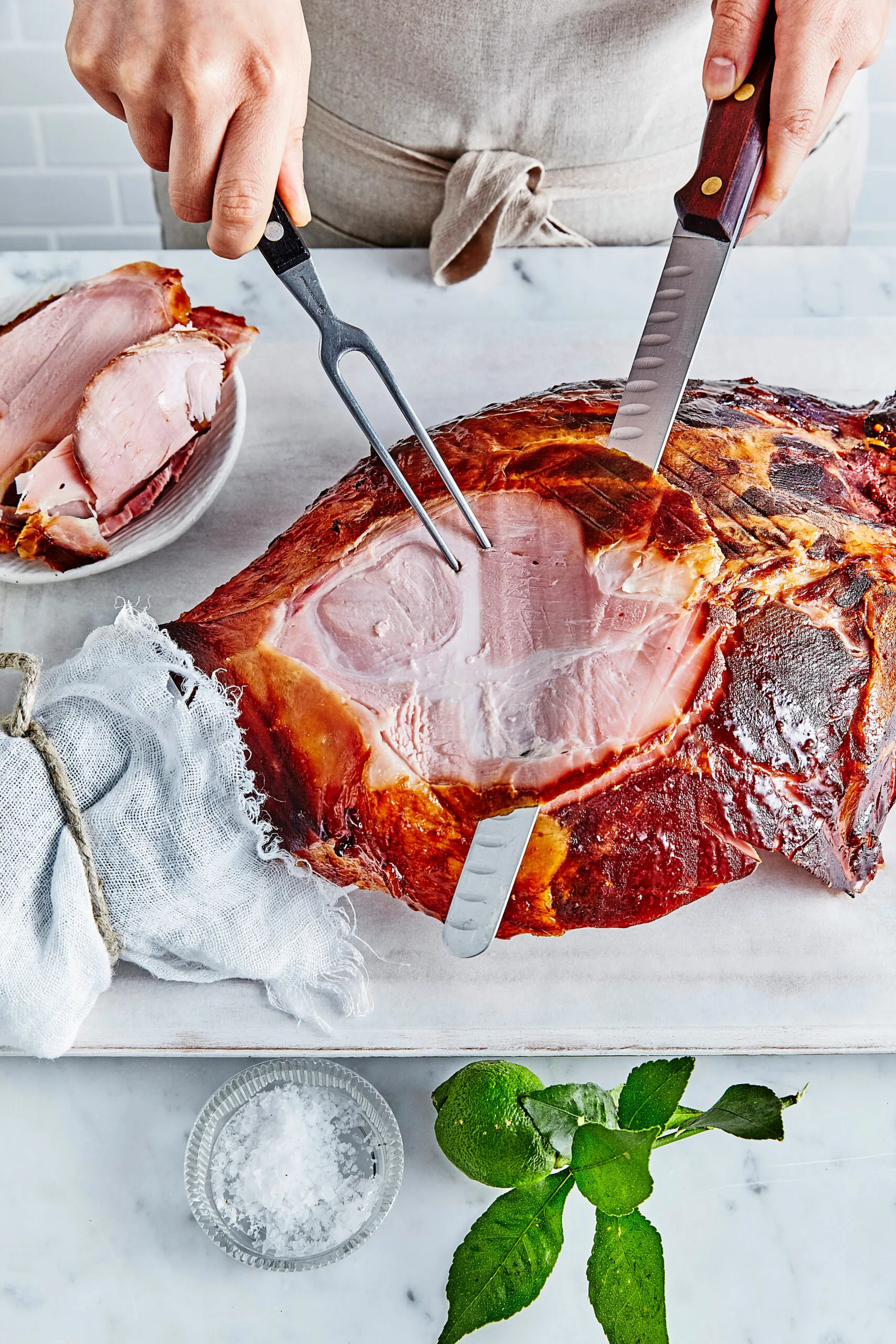Carving the underside of a ham parallel to the bone is the best way to create nice even slices.
