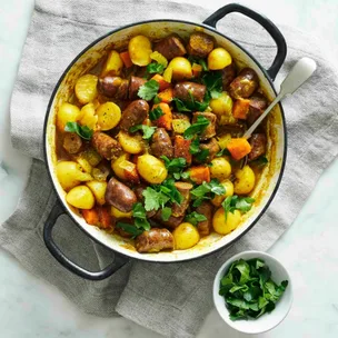 easy curried sausages in a pot with potato and carrot