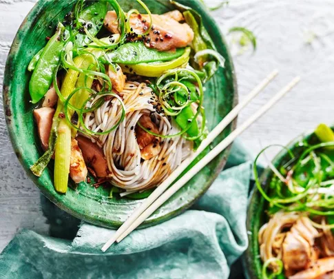 salmon soba noodles in a bowl with chopsticks