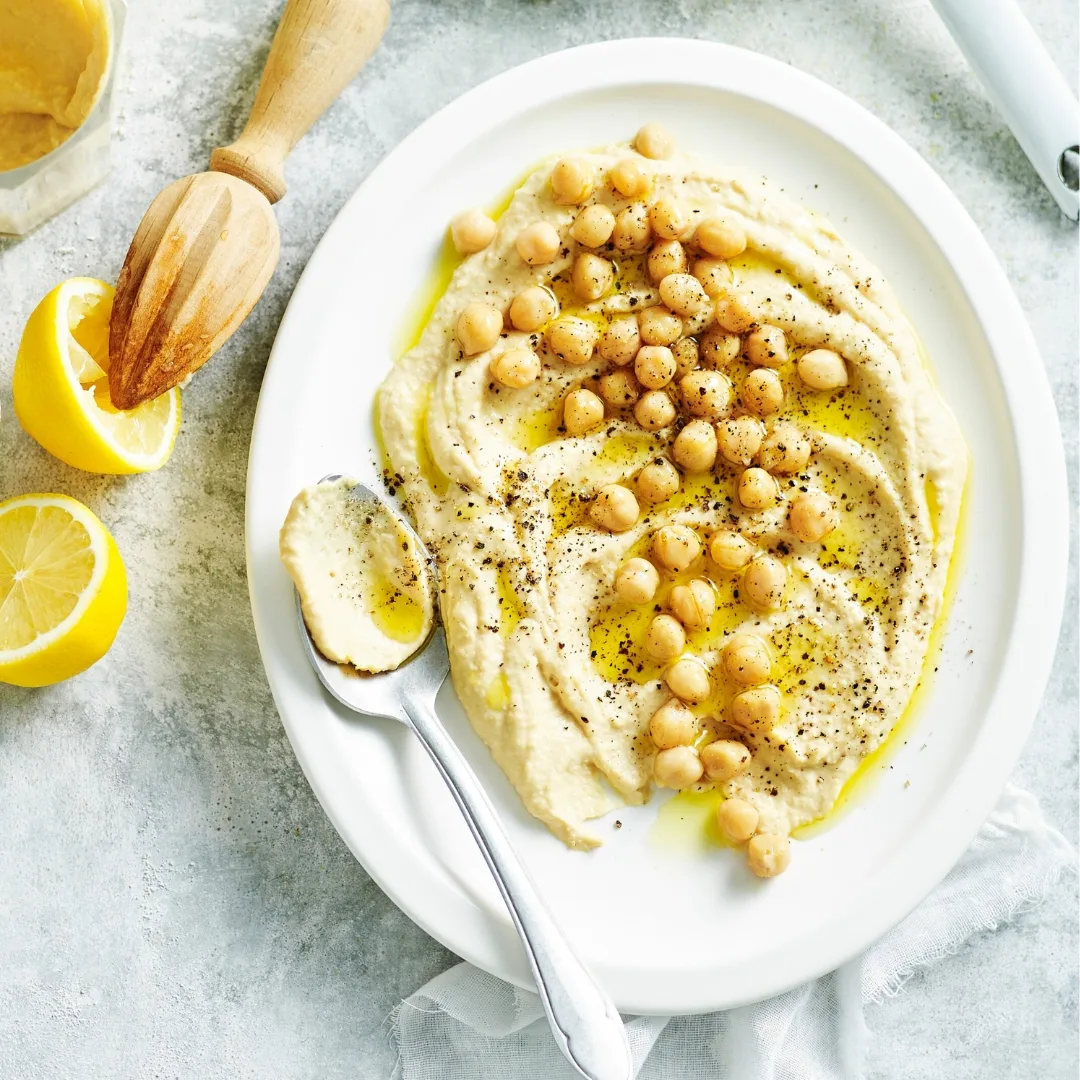 How to make basic hummus; hummus on a white plate