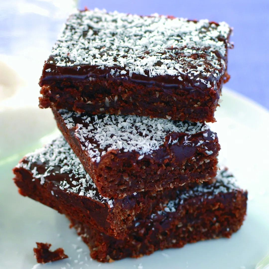 stack of four chocolate coconut slice pieces