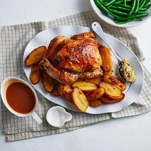 roast chicken with herb stuffing served with roast potatoes and steamed beans
