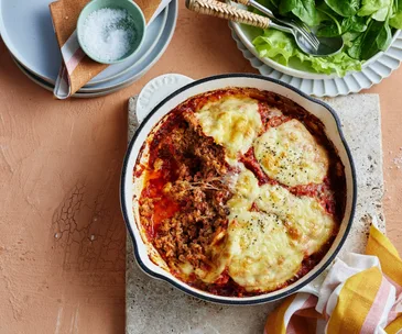 meatloaf in a skillet topped with cheese