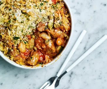 A white bowl filled with sausage and butter bean cassoulet