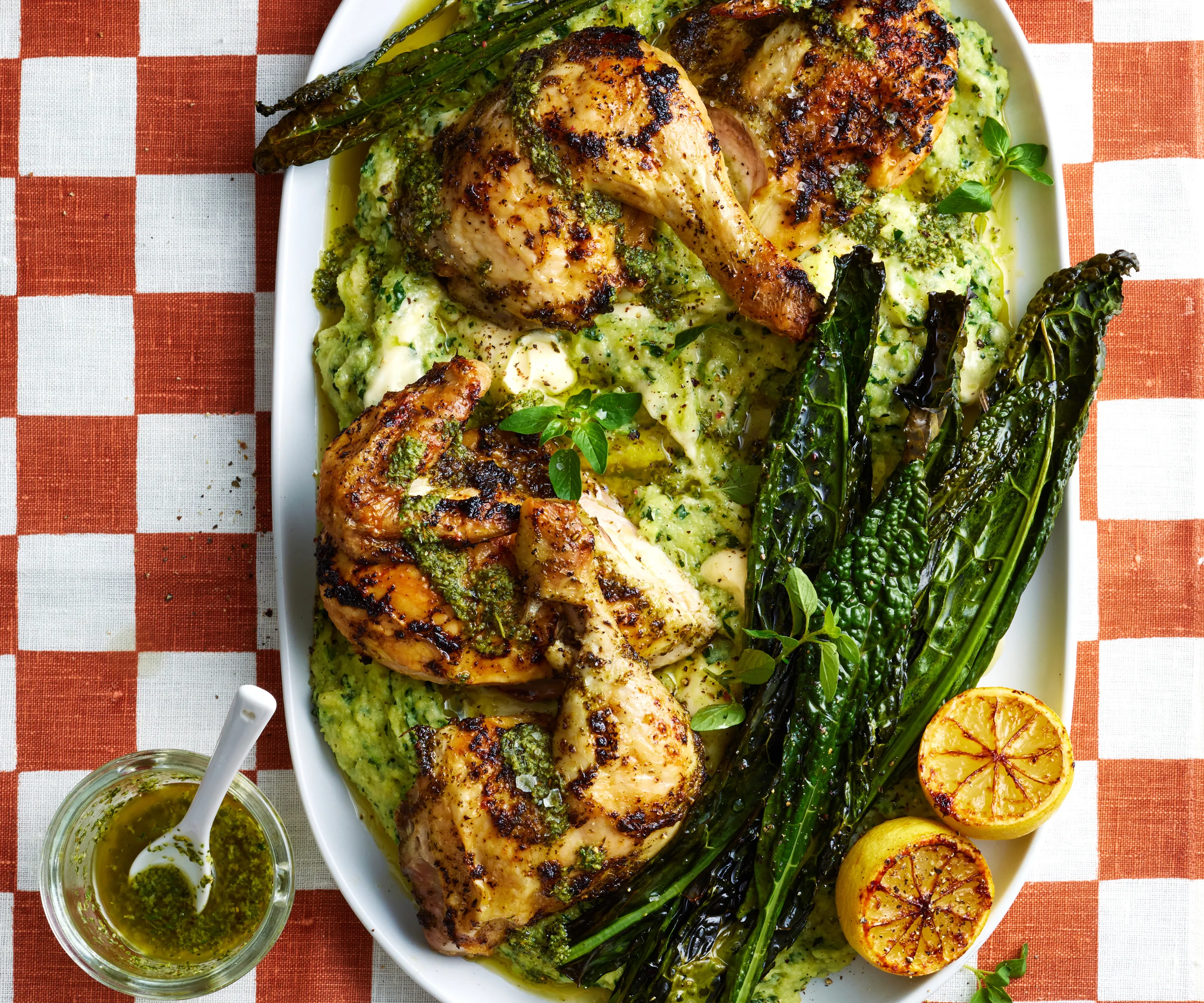 roast chicken pieces on a bed of cheesy polenta