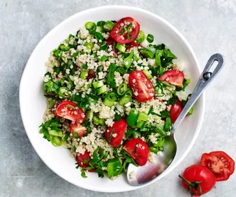 White bowl of quinoa tabbouleh.