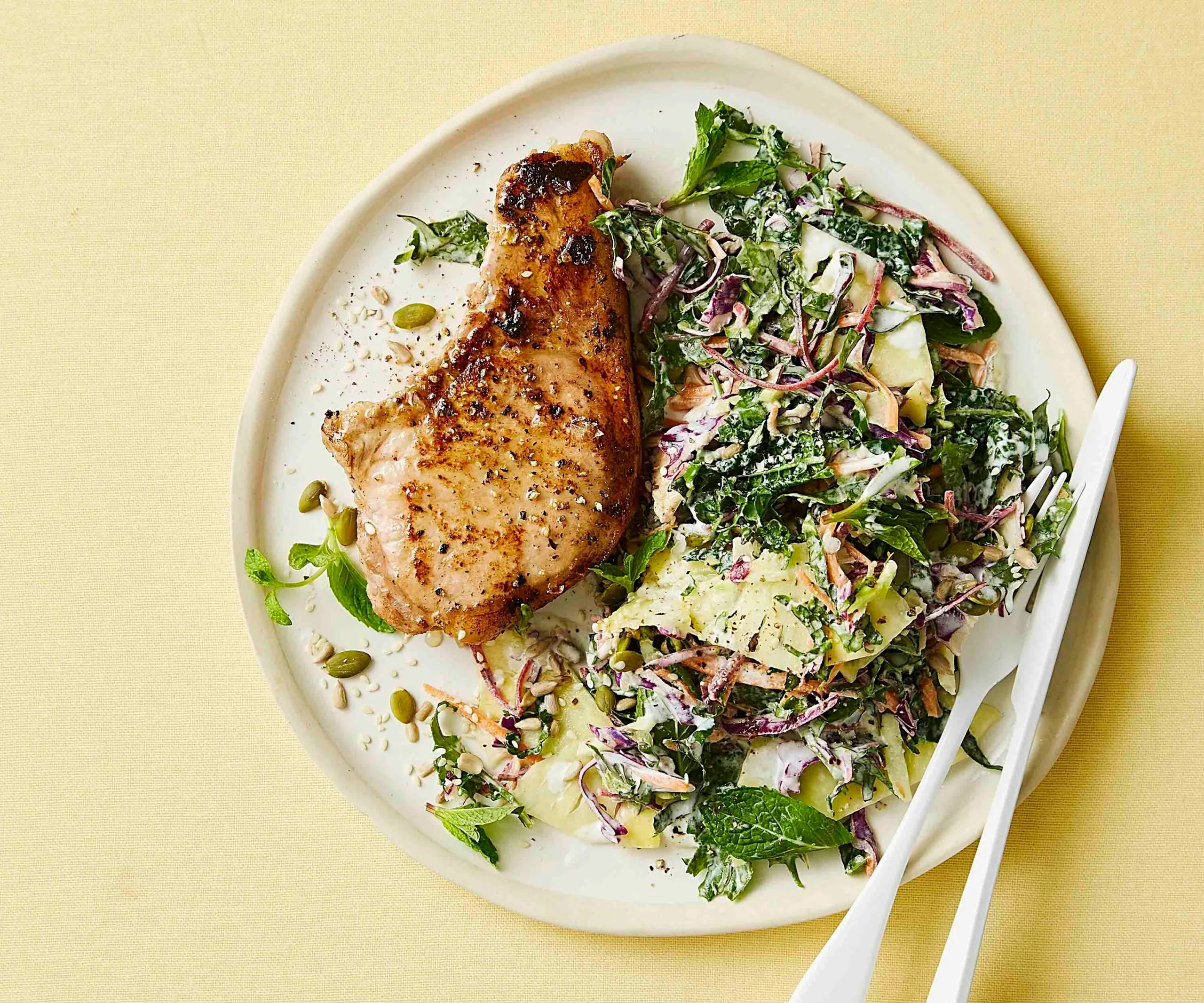 Plate of with pineapple slaw and a mustard pork cutlet.