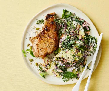Plate of with pineapple slaw and a mustard pork cutlet.