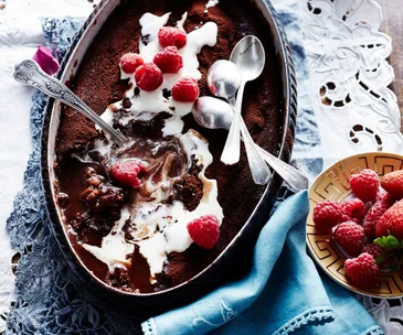 Mocha self-saucing pudding served with raspberries and cream