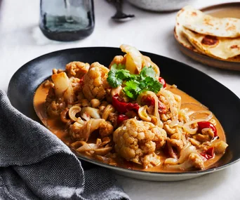 Bowl of cashew and cauliflower curry.