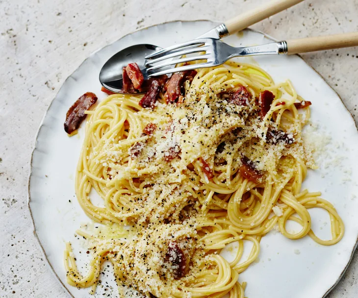 spaghetti carbonara on a plate with cutlery