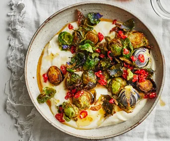 Fried Brussels sprouts on a bed of blended ricotta, drizzled with chilli honey