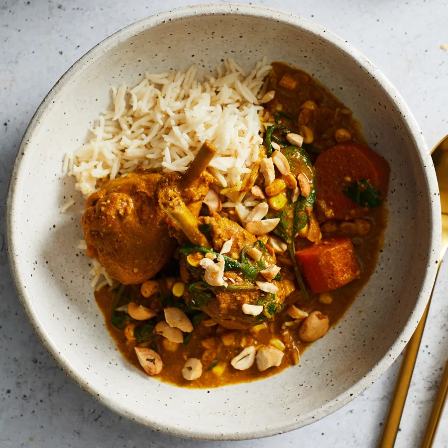 Slow cooker butter chicken with rice in a bowl