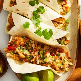 slow cooker pulled chicken fajitas with lime wedges