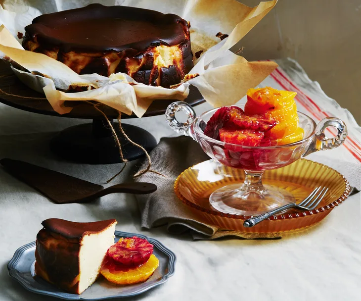 Basque cheesecake served with orange slices and marmalade