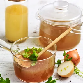 slow cooker beef bone broth in a glass saucepan