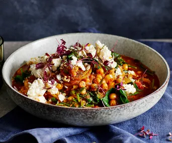 Large bowl of chickpea, spinach and paneer rogan josh