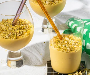 Three glasses of coconut, mango and lime lassi 